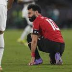 Liverpool star Mohamed Salah pictured on the floor after picking up an injury vs Ghana at AFCON